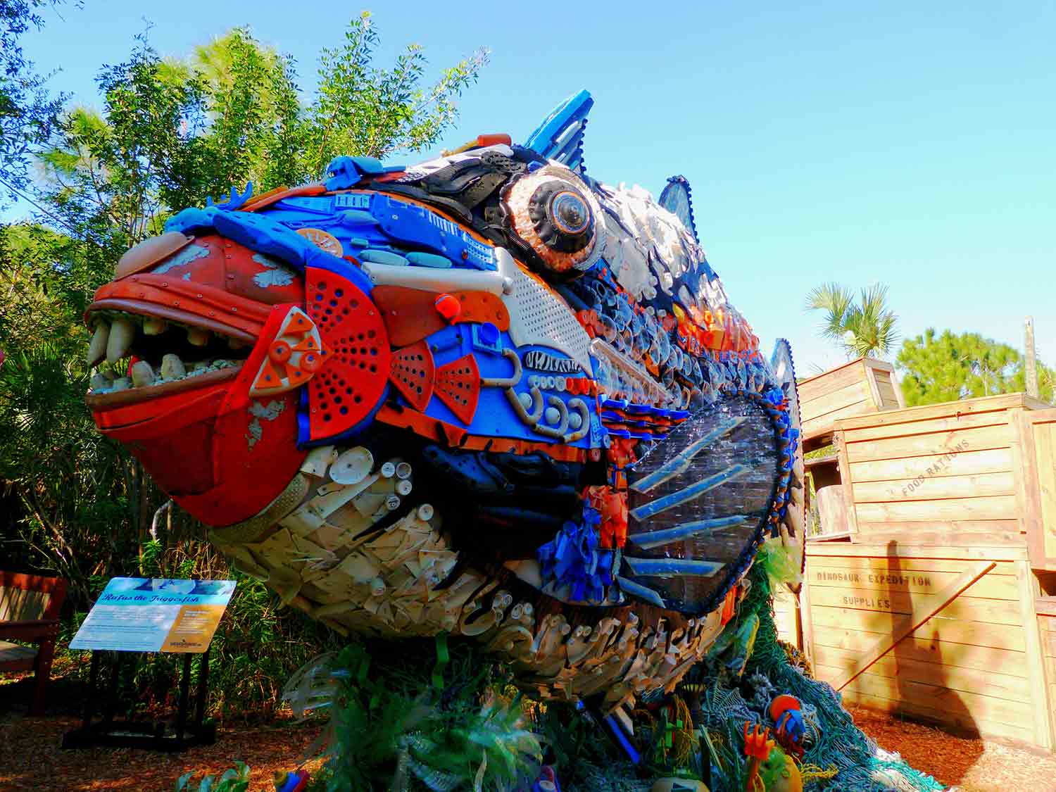 A large multicolored sculpture of a fish made from plastic