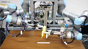 Two robot arms holding a banana that is half-peeled