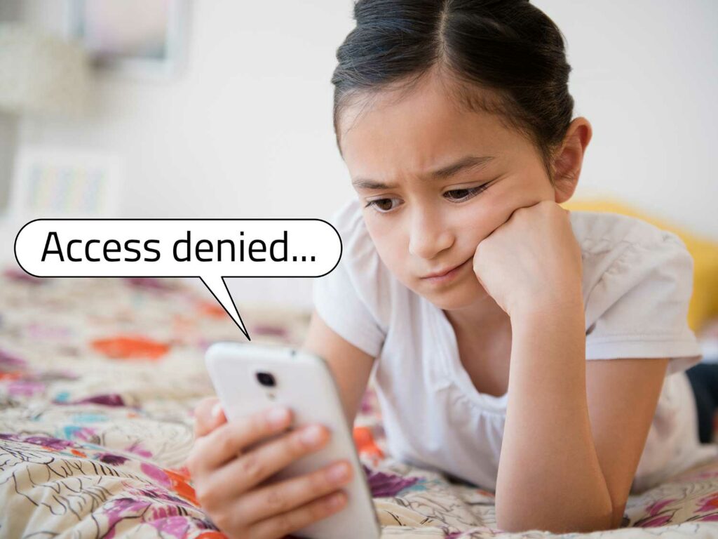 Young girl sadly staring at her phone, being denied access to an app