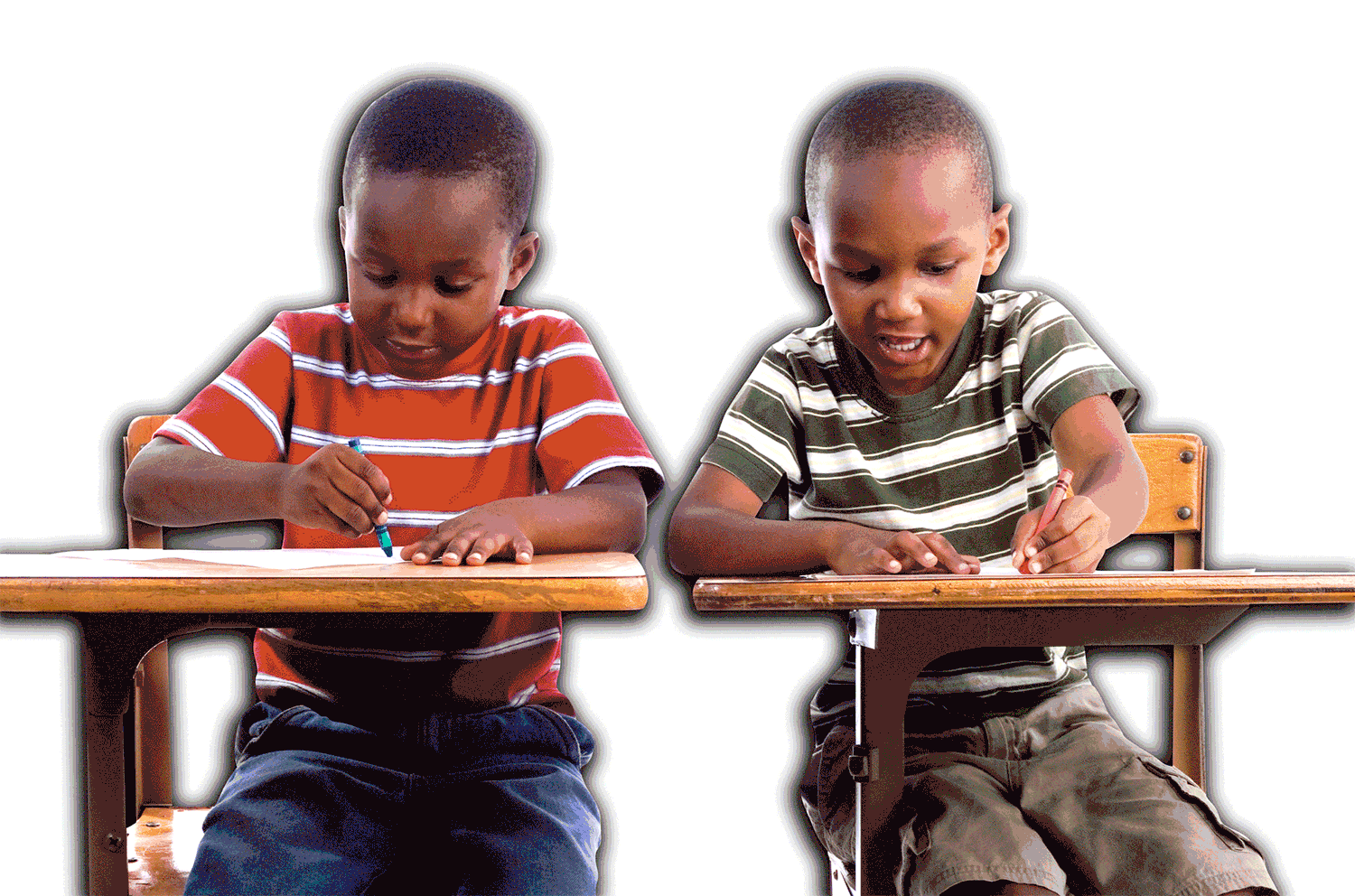 Two boys color at desks while many large crayons appear behind them.