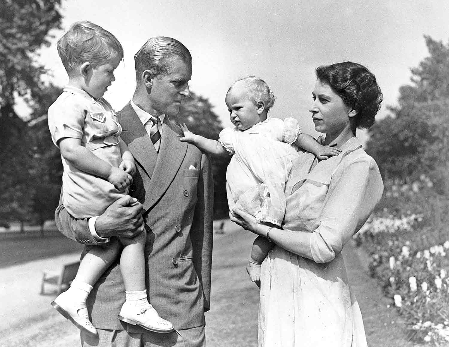 This photo from the 1950s shows Queen Elizabeth and Prince Philip with their two oldest kids, Prince Charles and Princess Anne.