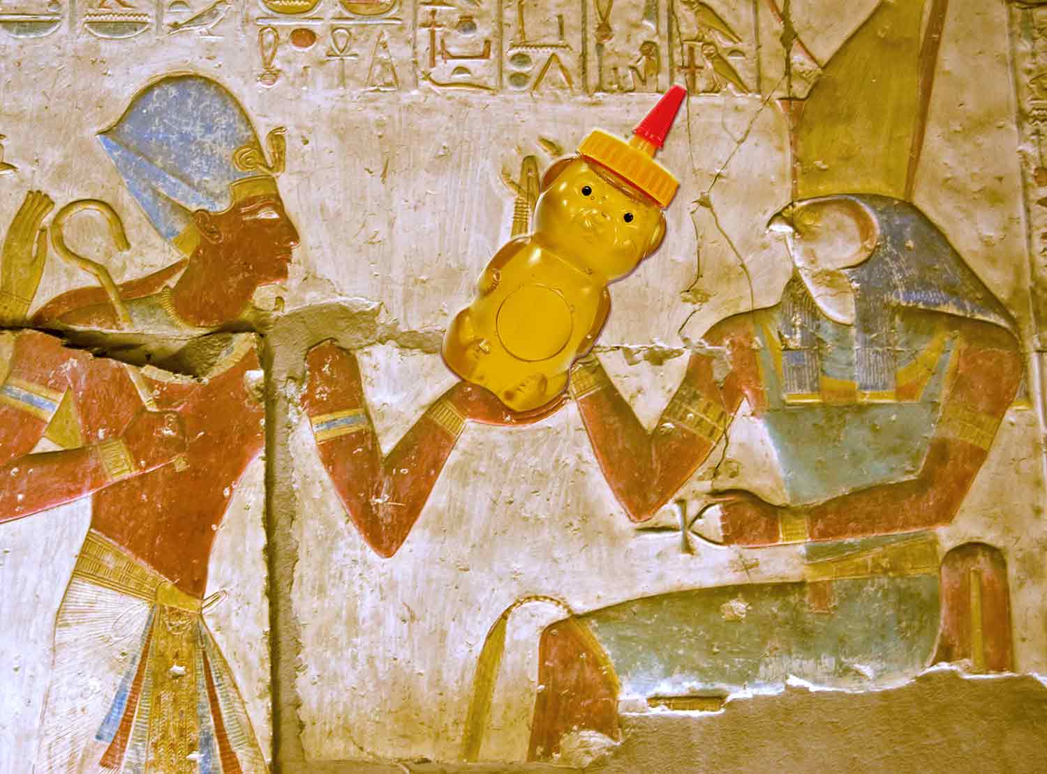 A bear-shaped container of honey superimposed on a carving of an ancient Egyptian pharoah and another person.