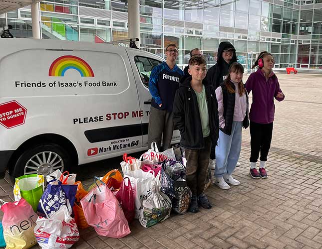 Isaac Winfield (front, left) and his family have a van so they and their friends can take food to people who need it.