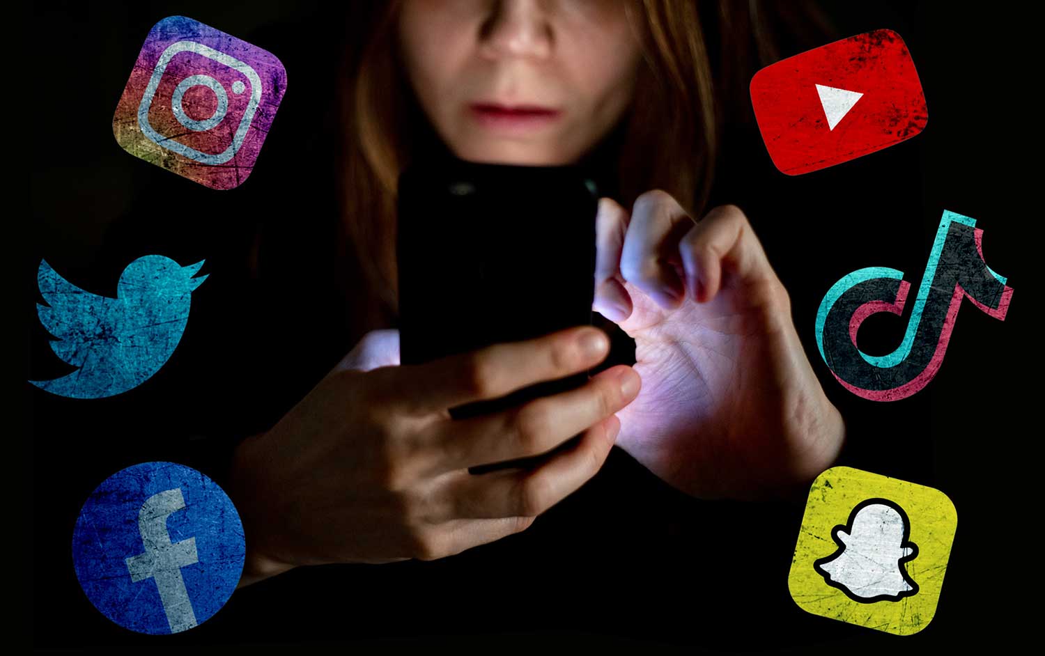 A woman uses her phone in a darkened space with the logos of various platforms on either side of her.