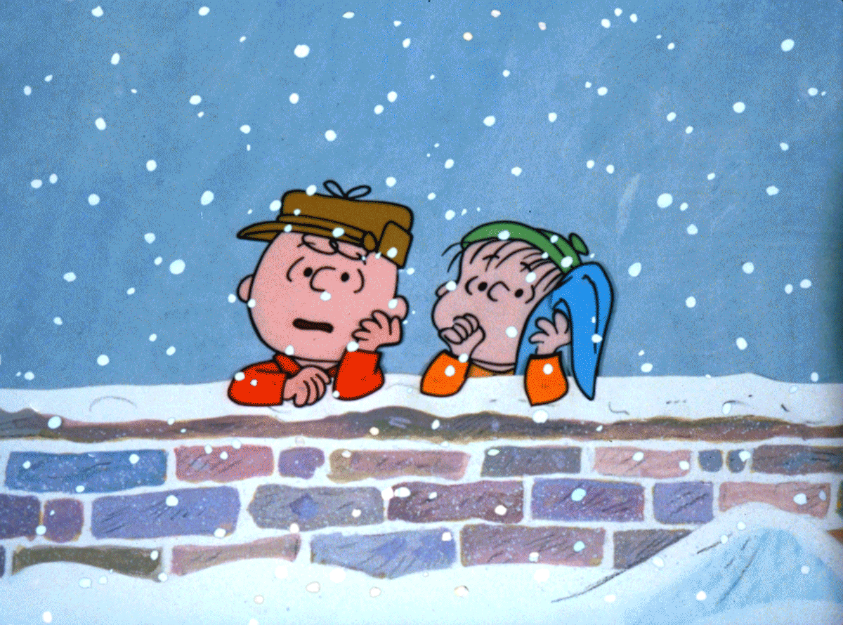 Charlie Brown and Linus watch as snow falls.