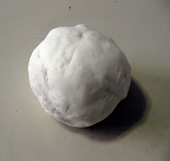 A ball of white clay on a white surface