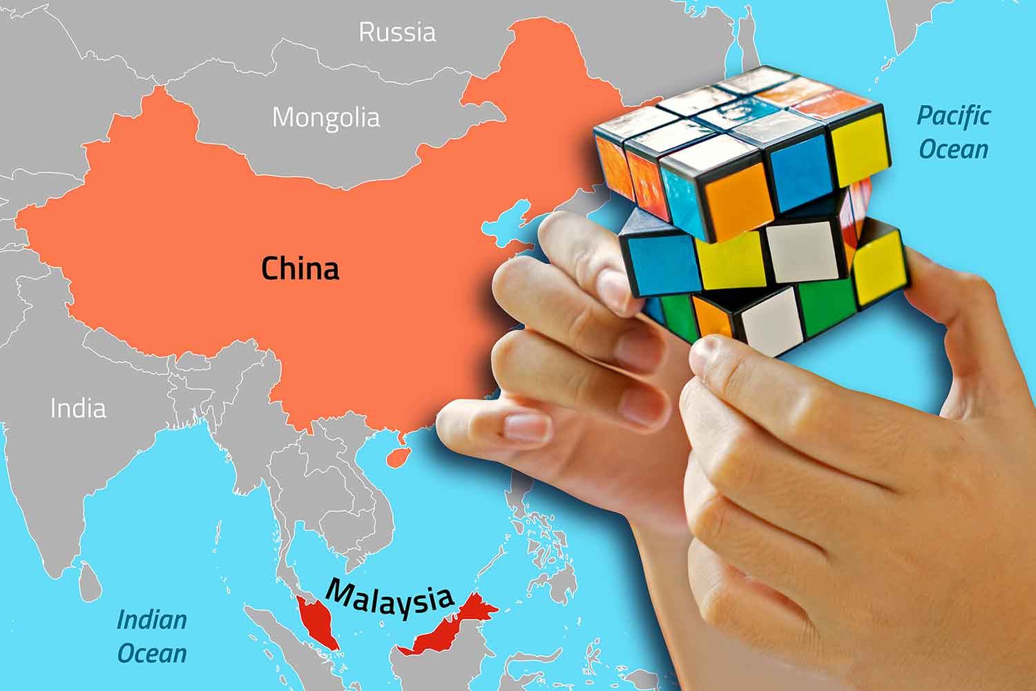 Two maps hold a Rubik’s Cube with a map highlighting China and Malaysia in the background.
