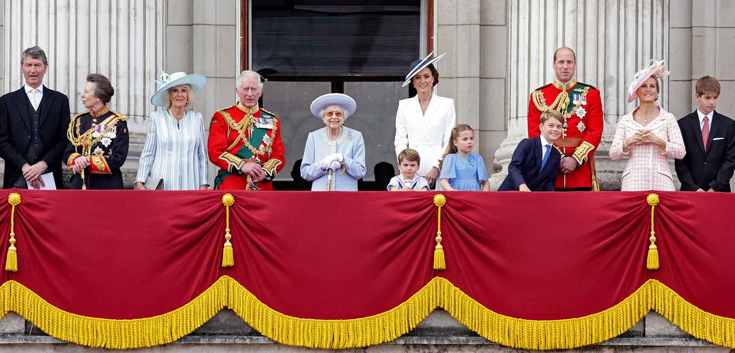 Members of the royal family including Prince Charles and Queen Elizabeth stand on a balcony together.