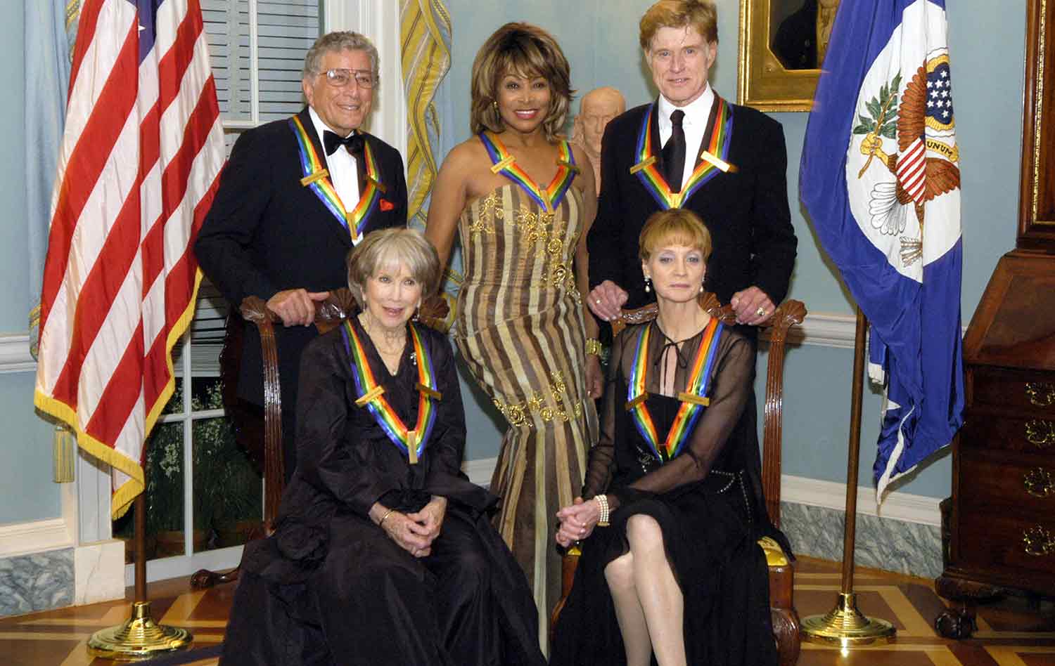Julie Harris and Suzanne Farrell are seated in front of Tina Turner, who stands between Tony Bennett and Robert Redford.