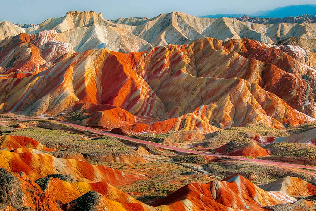 Mountains with stripes of brown, white, yellow, orange, and red.