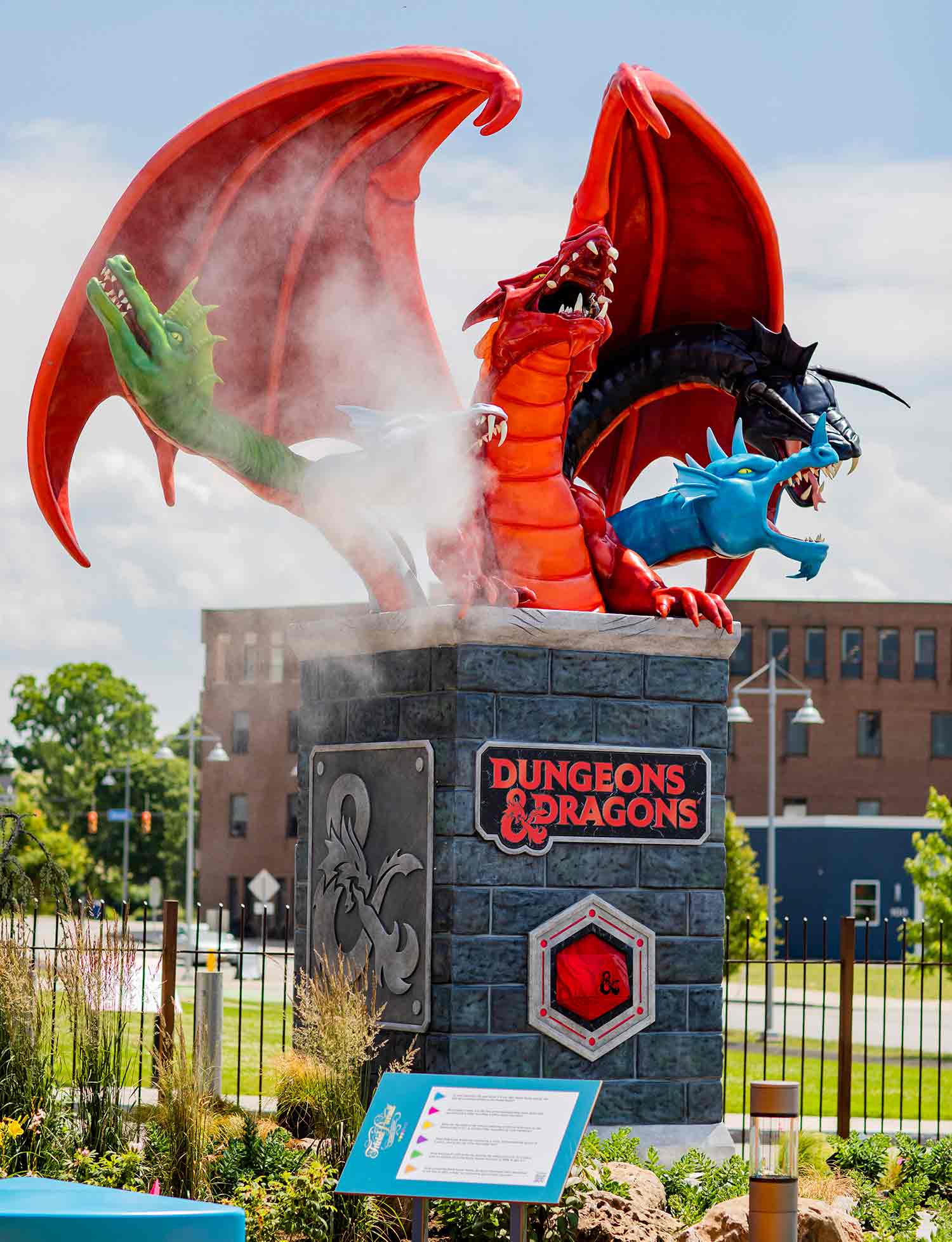 A five-headed dragon emerges from a column with a Dungeons and Dragons sign on it.