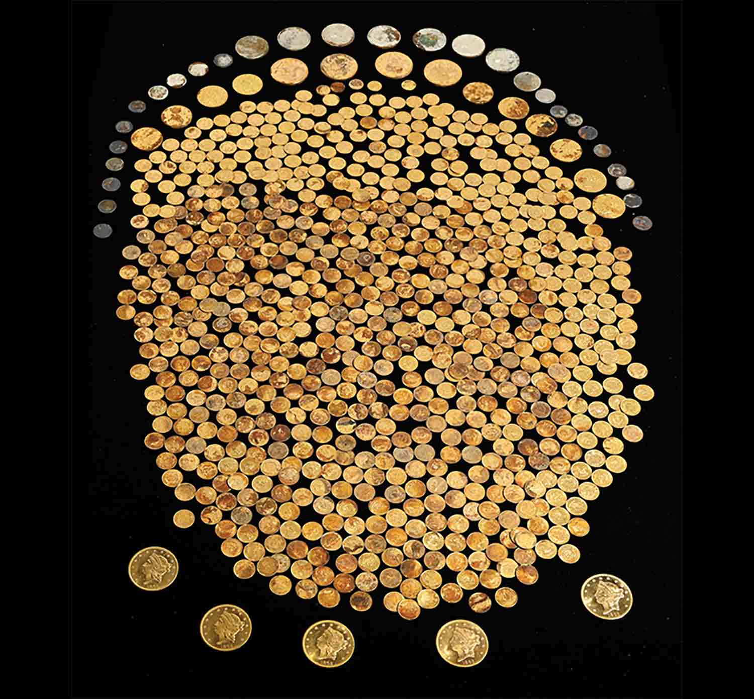 A large group of gold coins with larger gold and silver coins arranged around the pile.