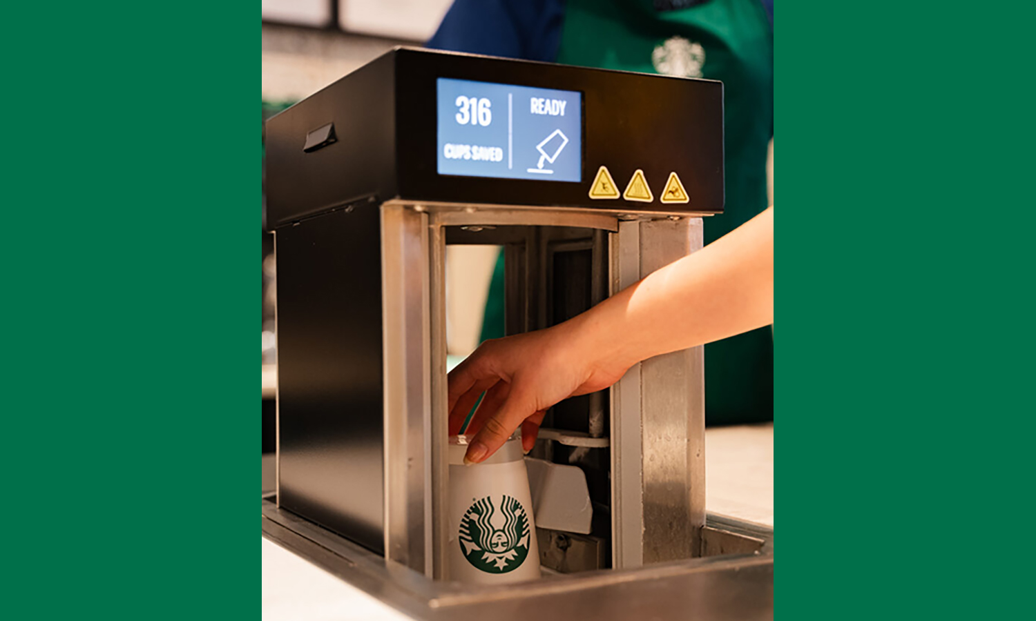 A reusable cup is placed upside down in a cleaning device that says “316 cups saved.”