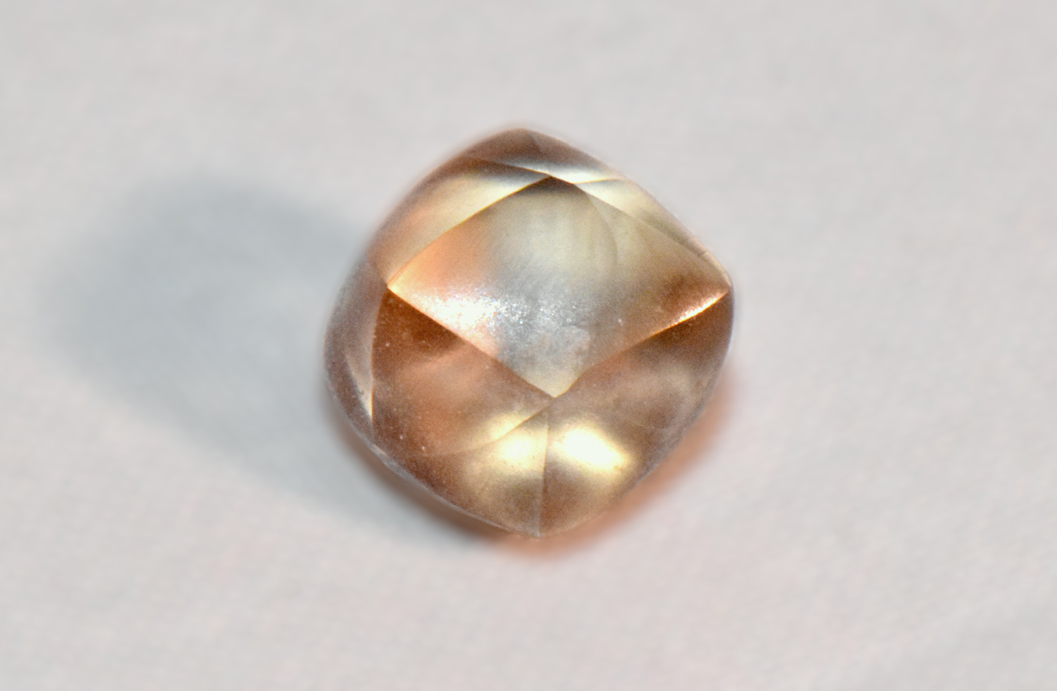 A light brown diamond against a white background