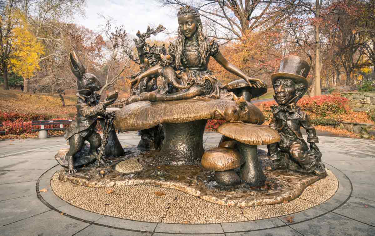 A large bronze sculpture shows Alice, the Mad Hatter, and the White Rabbit.