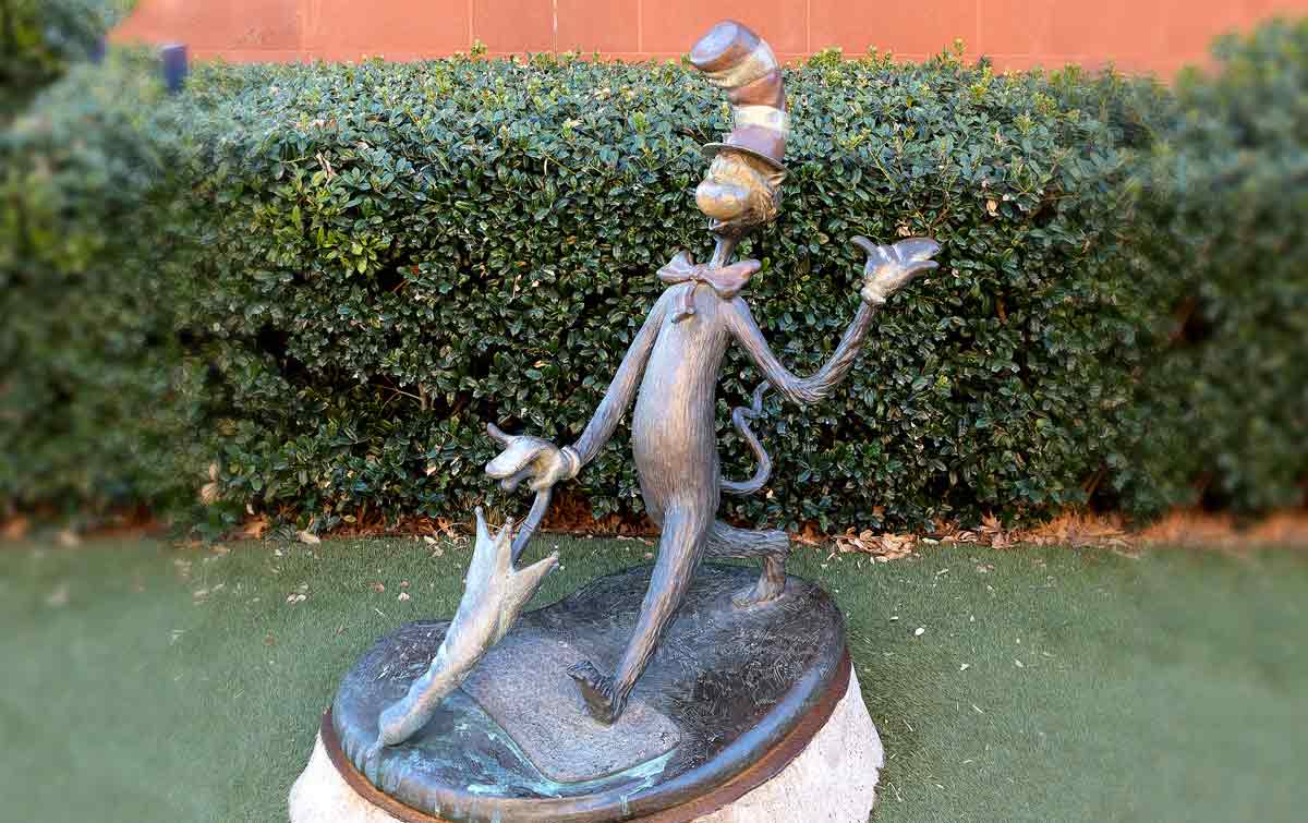 Sculpture showing the Cat in the Hat mid stride and using an umbrella as a walking stock.