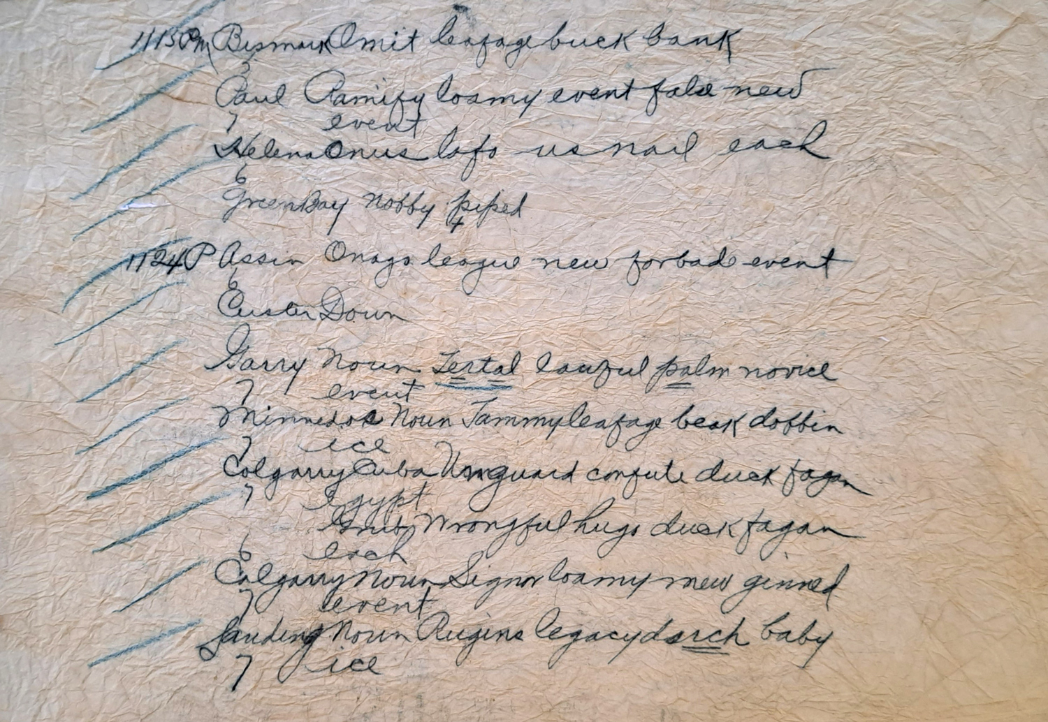 A wrinkled piece of paper with several handwritten lines.