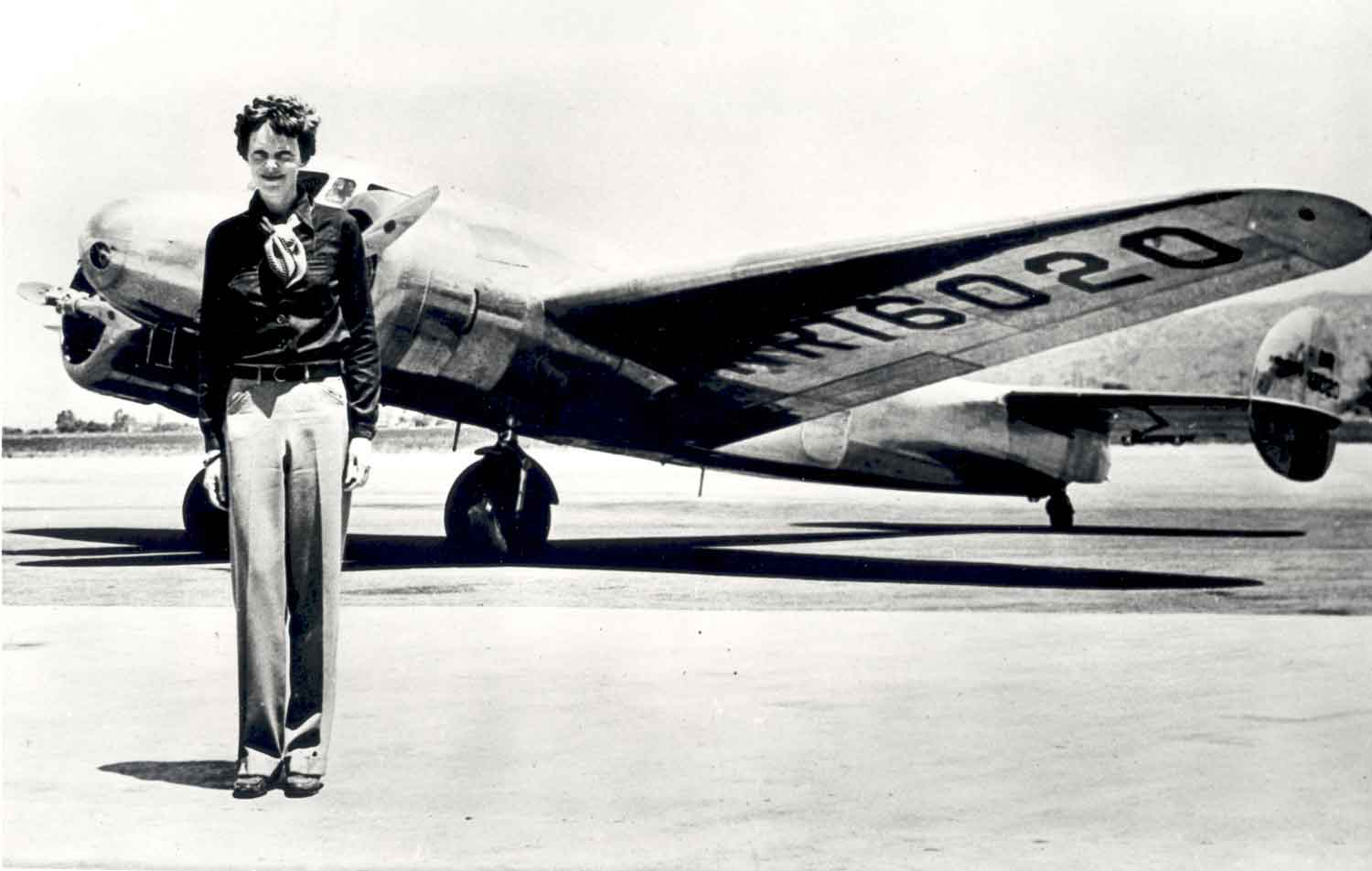 Amelia Earhart poses in front of her plane.