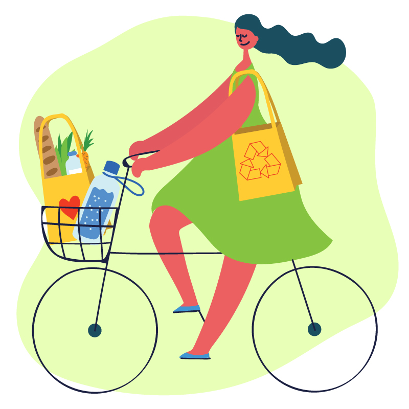 A woman rides a bike with a recycled bag on her shoulder and groceries in the basket.