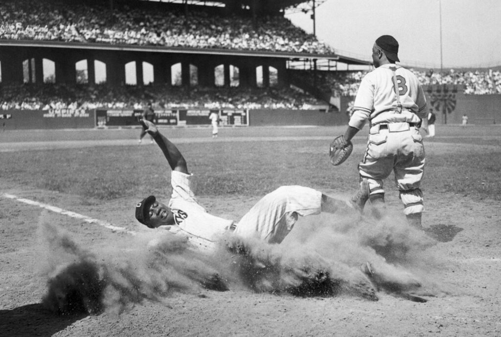 Josh Gibson slides into home plate.