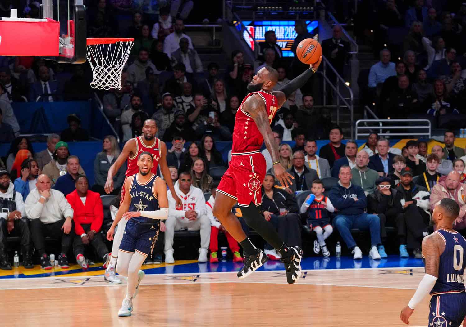 LeBron James appears to fly through the air while taking a ball to the basket.