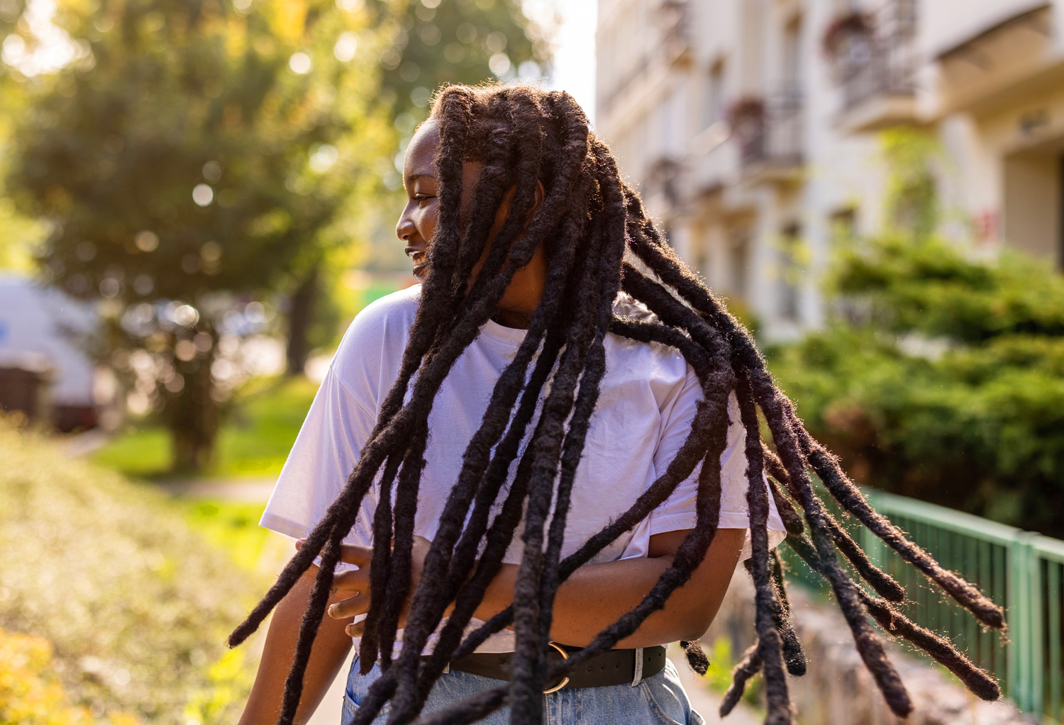 A woman with a natural hairstyle tosses her hair.