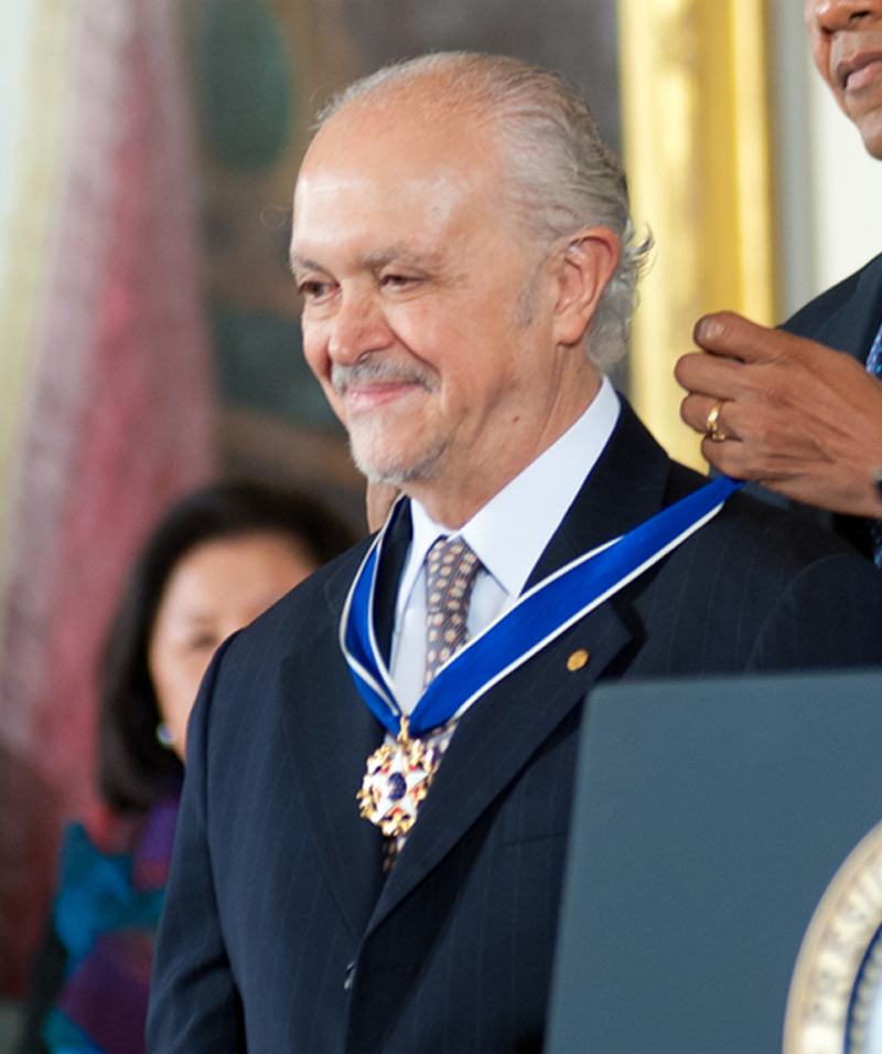 Mario Molina smiles as President Barack Obama puts a medal around his neck.