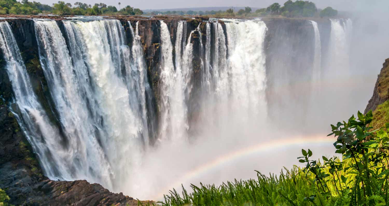 Victoria Falls is shown with a rainbow in front.