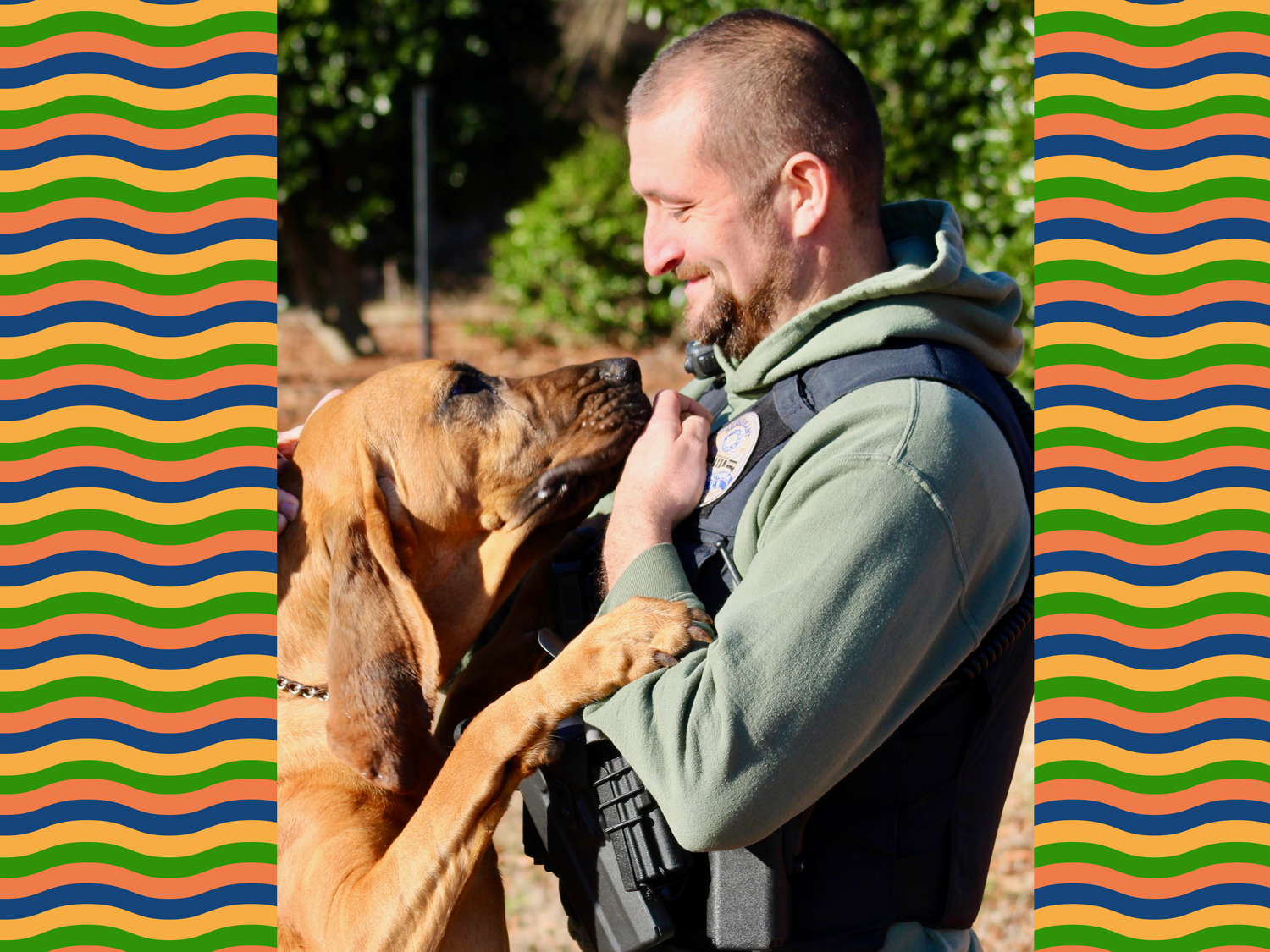 Bo the bloodhound has his two front paws on Sergeant David Rowland as the two are face to face.