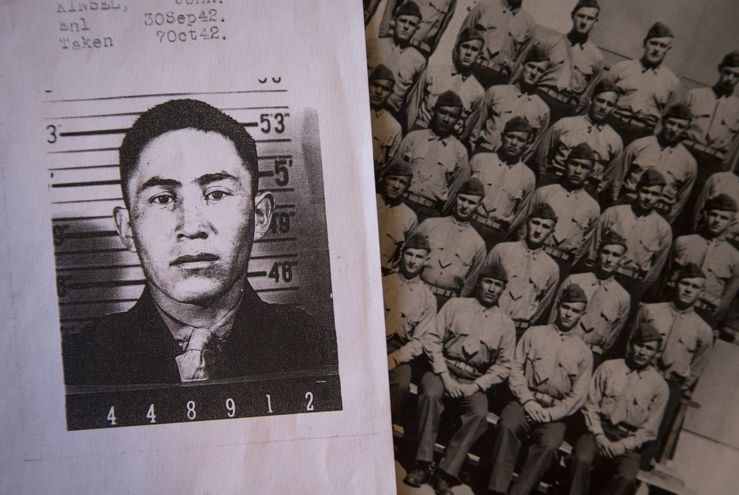 John Kinsel, Senior is a young man in uniform in an enlistment photo and a photo seated with his platoon.