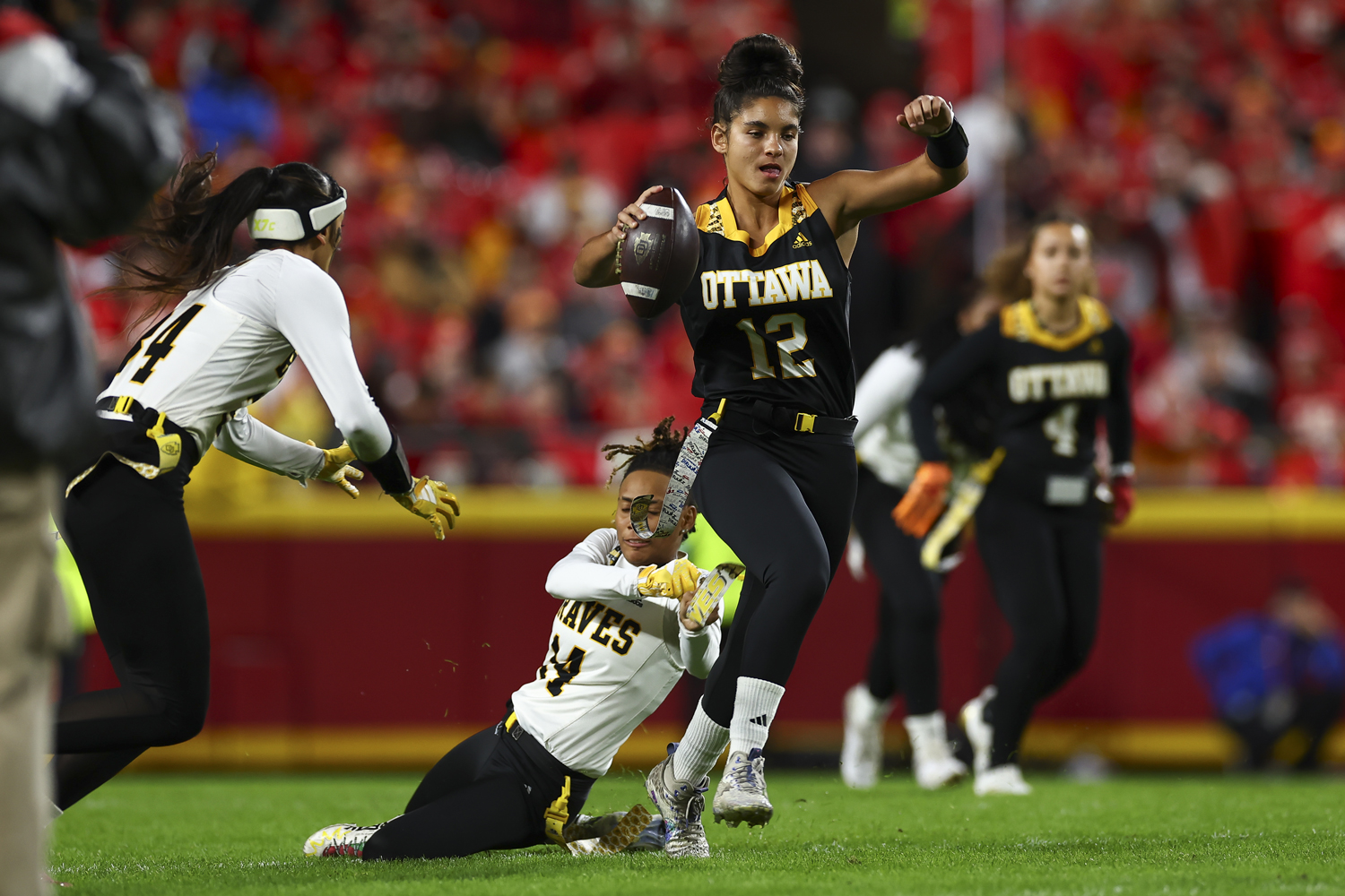 Olivia Cadiz (#12) holds the ball as Susann Kaufmann reaches for Cadiz’s flag.