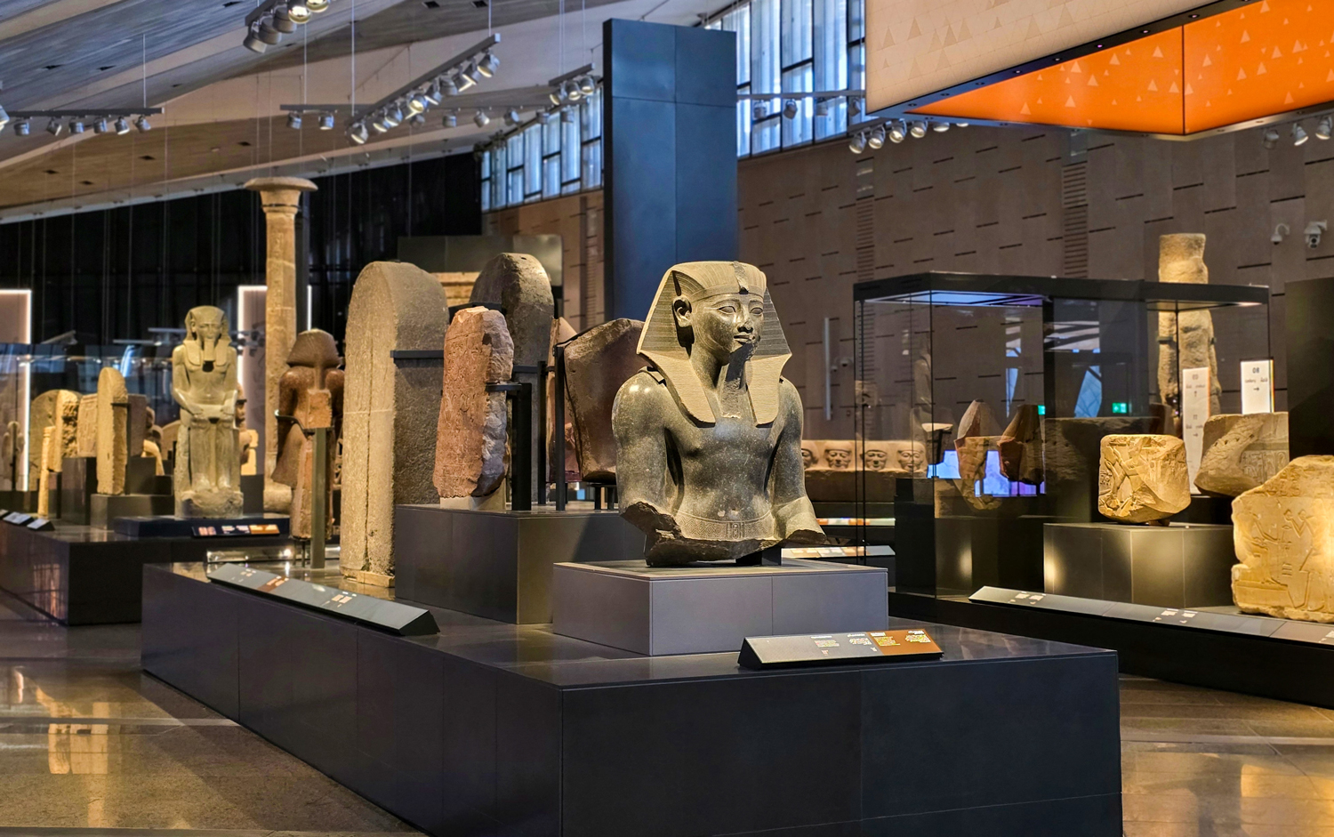 A large atrium containing many ancient Egyptian statues and other sculptures