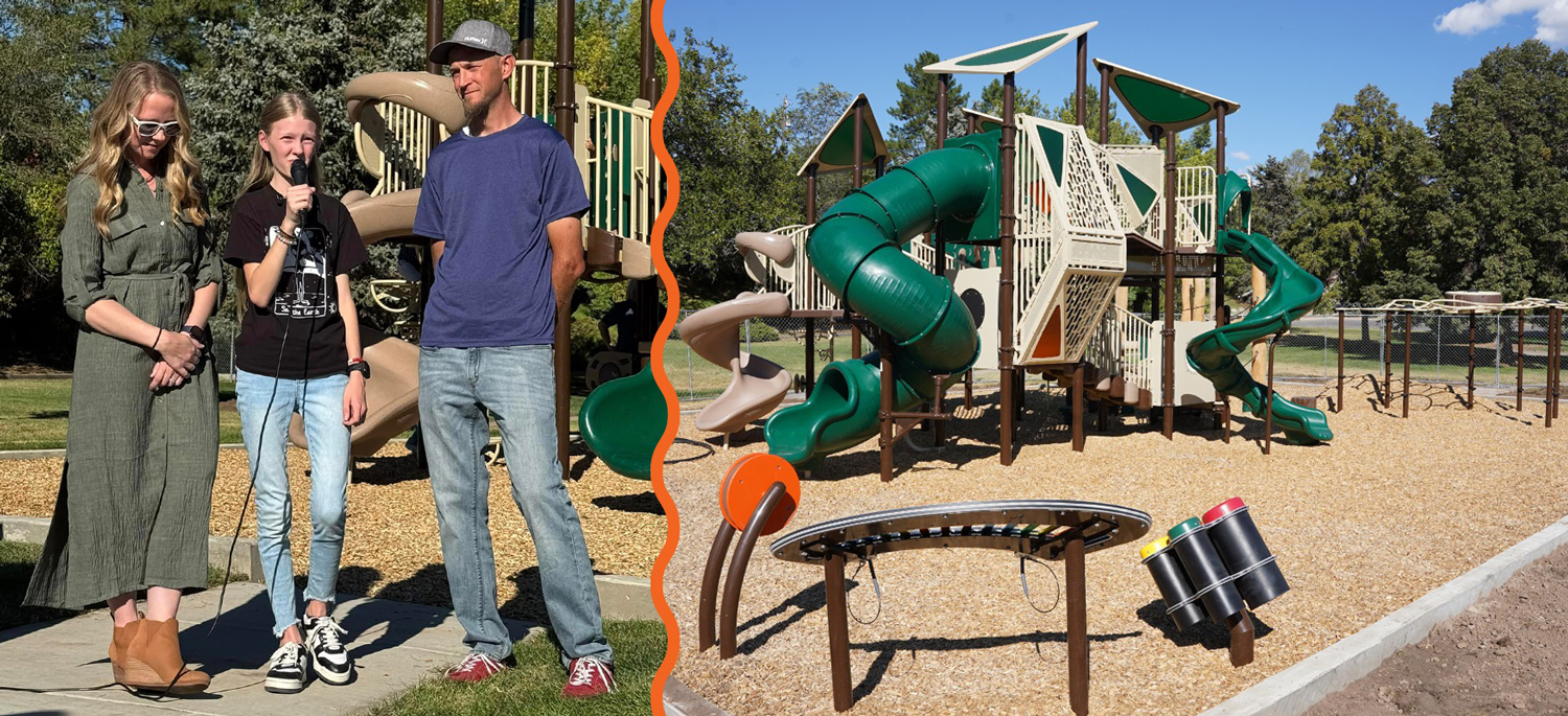 Rosili Olson stands in front of a playground and speaks into a microphone as a man and a woman stand on either side of her.