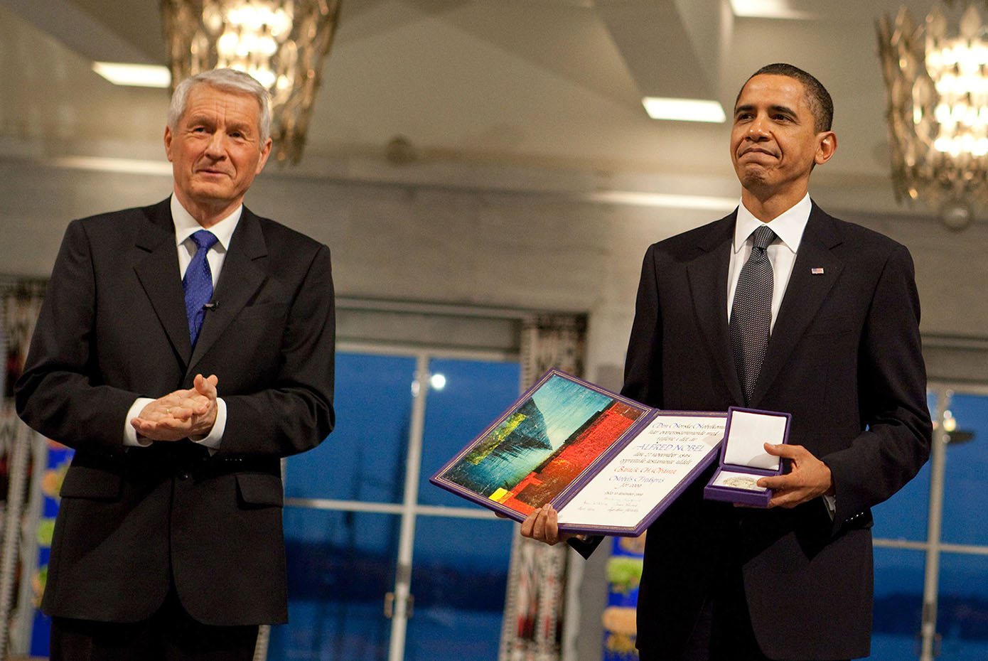 Nobel Committee Chairman Thorbjorn Jagland stands next to President Obama, who holds the Nobel Prize medal and diploma.