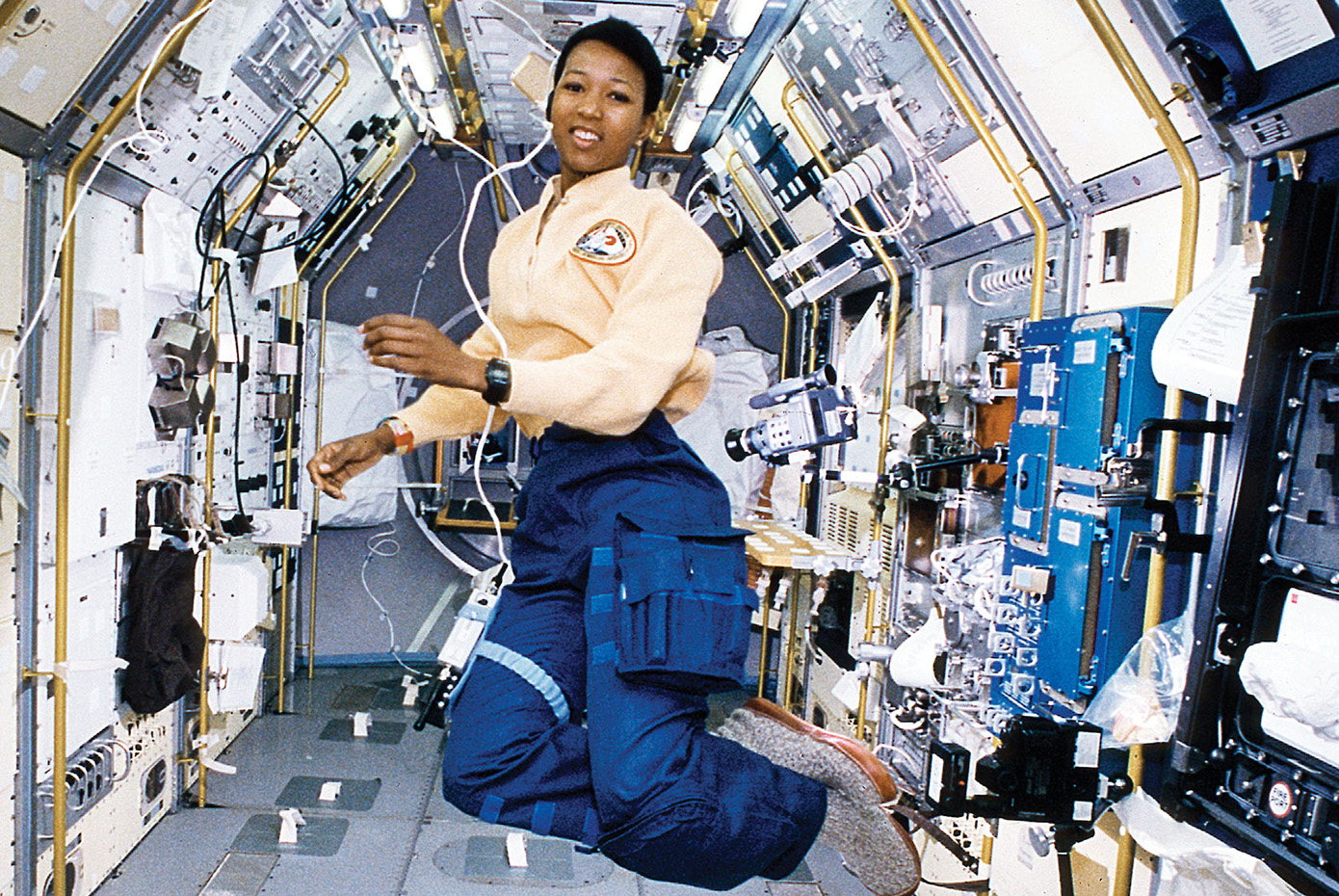 Mae Jemison poses inside a space shuttle.