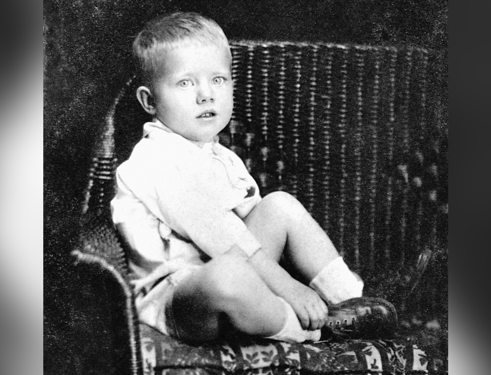 Jimmy Carter as a toddler, sitting in a wicker chair.