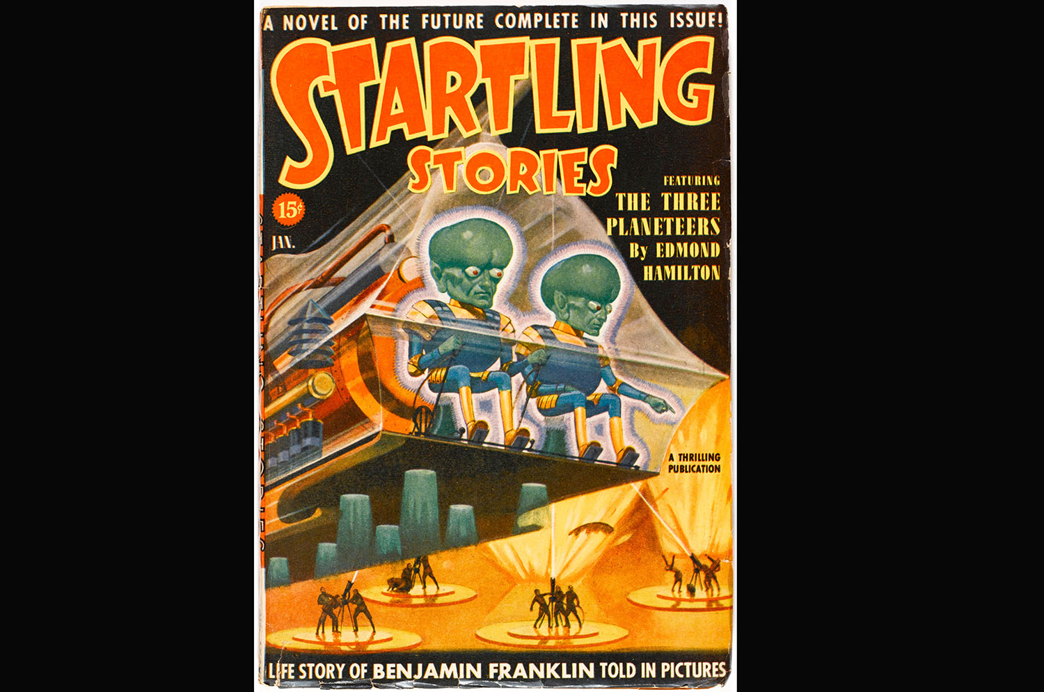 The cover of a magazine called Startling Stories shows giant green aliens on a ship invading Earth.