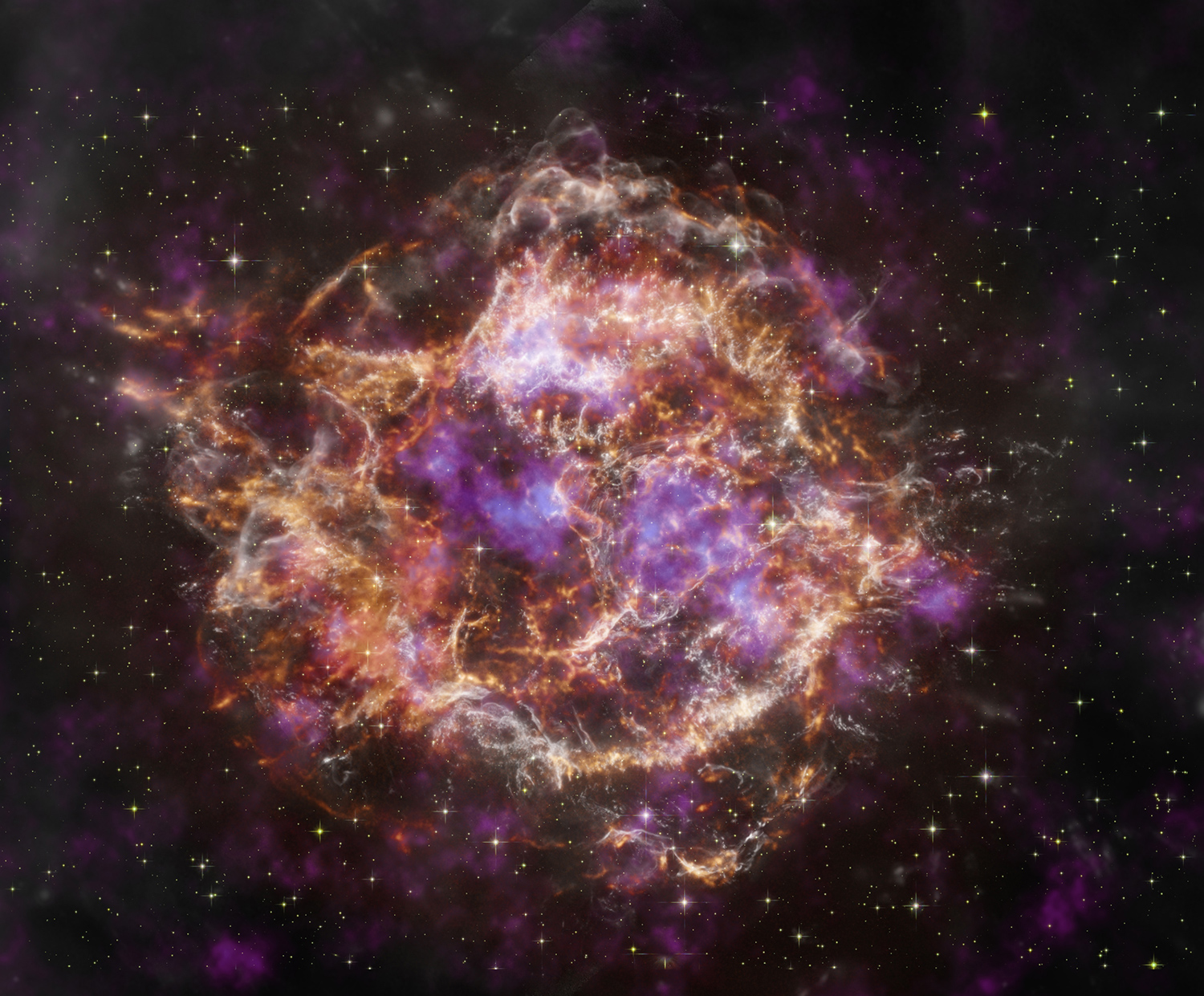 Cassiopeia A, the remnants of a supernova, appears as streams of white, purple, and orange light making an imperfect circle in space.