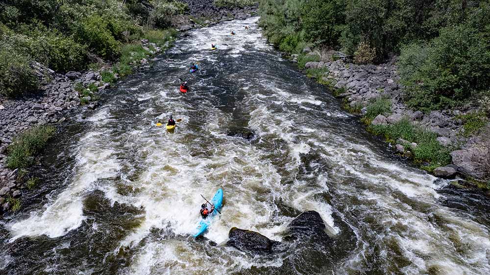 Overhead view of kayakers on the white water of the Klamath River.