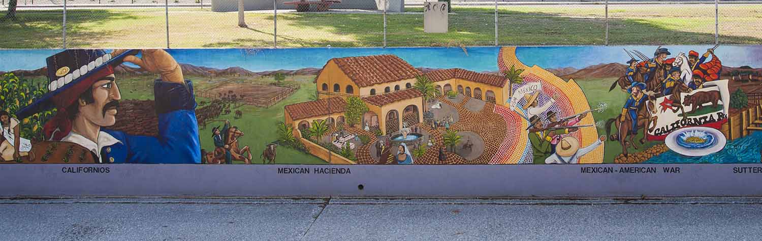 Three panels from the Great Wall of Los Angeles show a man in a sombrero, a hacienda, and soldiers from the Mexican American War.