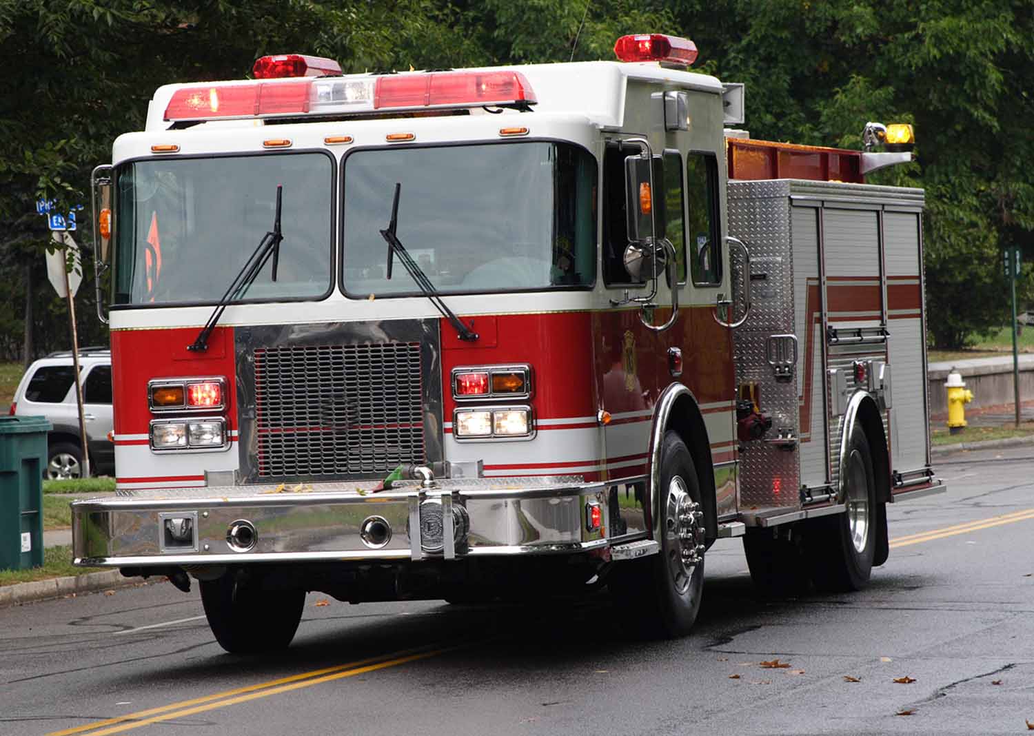 A fire truck travels down a street.
