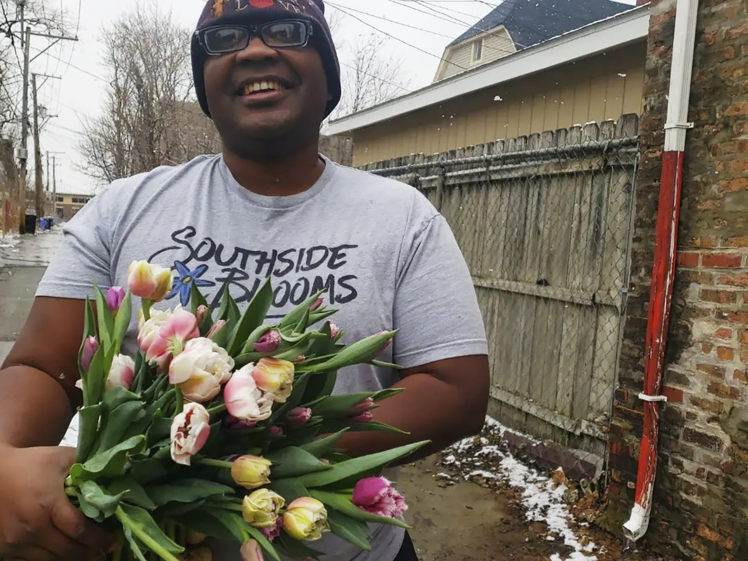 Quilen Blackwell smiles and poses with flowers