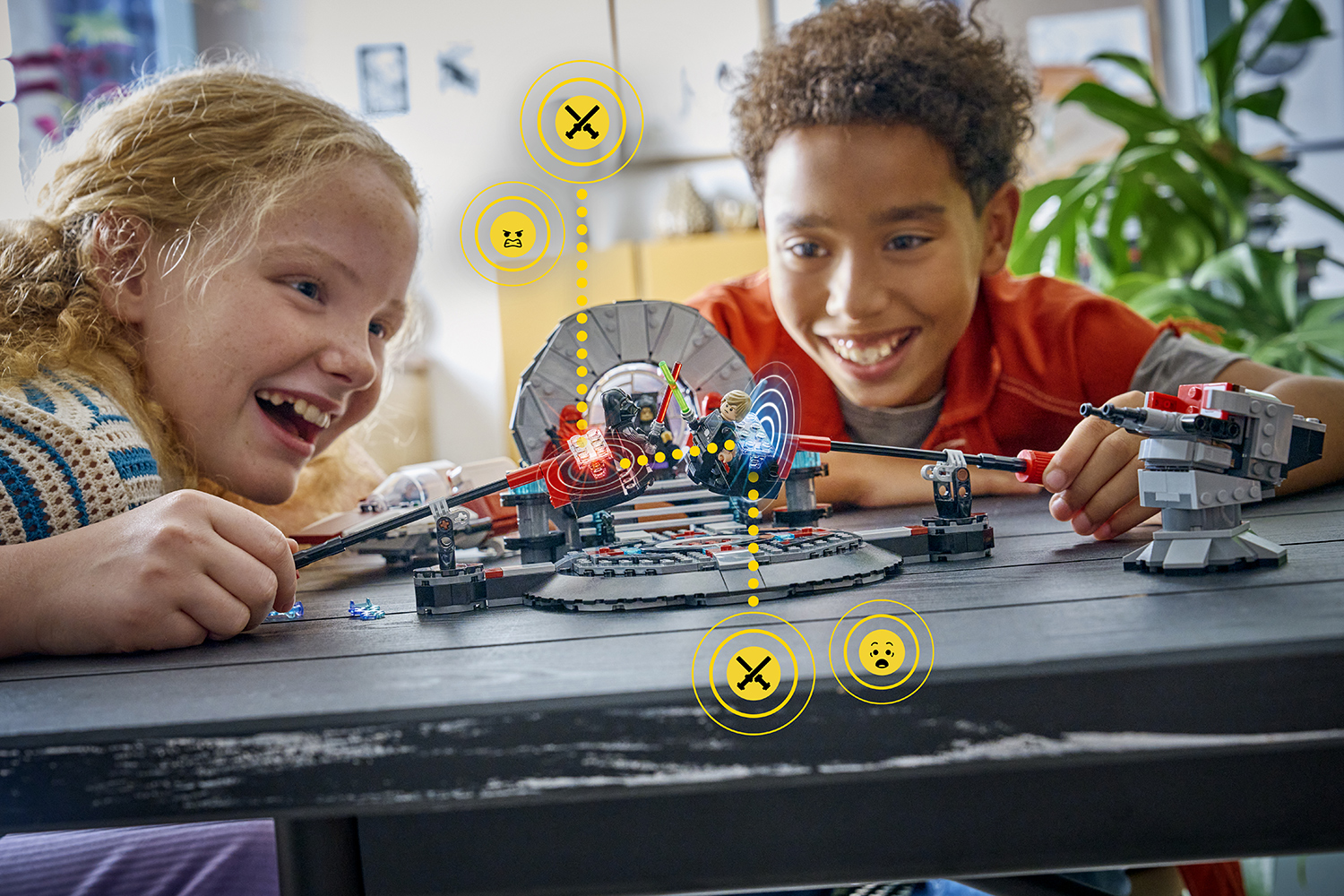 Two children play with a LEGO set while icons indicate that some bricks are responding to movement.
