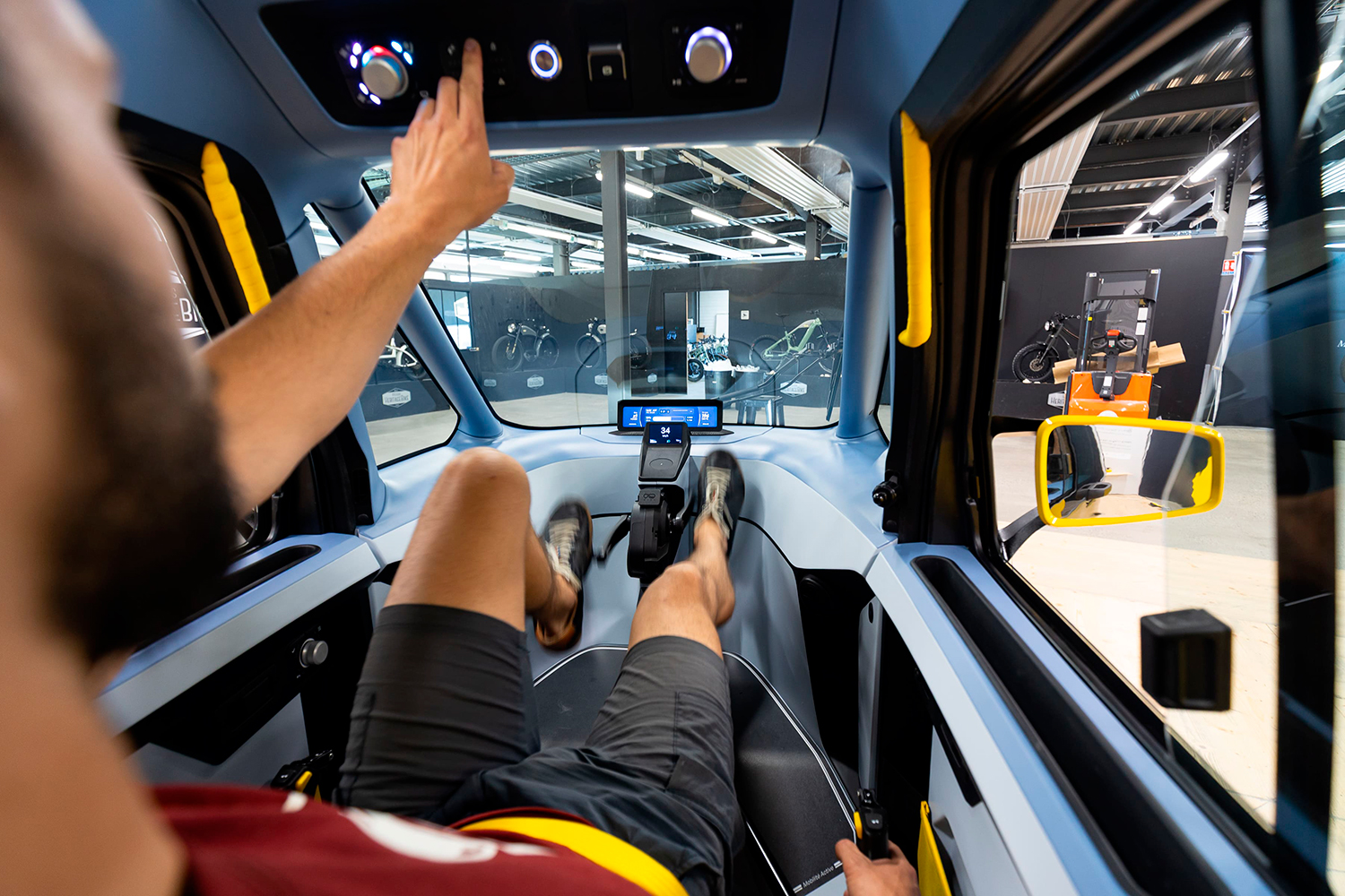 A man sits inside the Cixi Vigoz with his feet on the pedals.