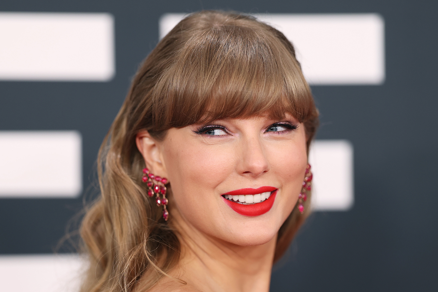 A closeup shows Taylor Swift smiling.