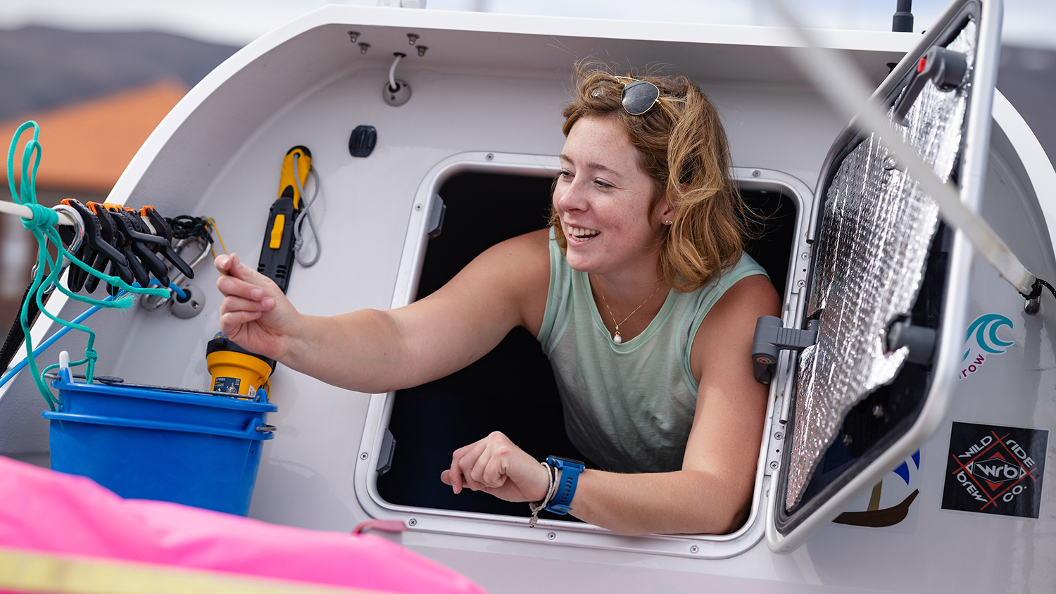 Taryn Smith smiles as she emerges from the cabin on her boat.