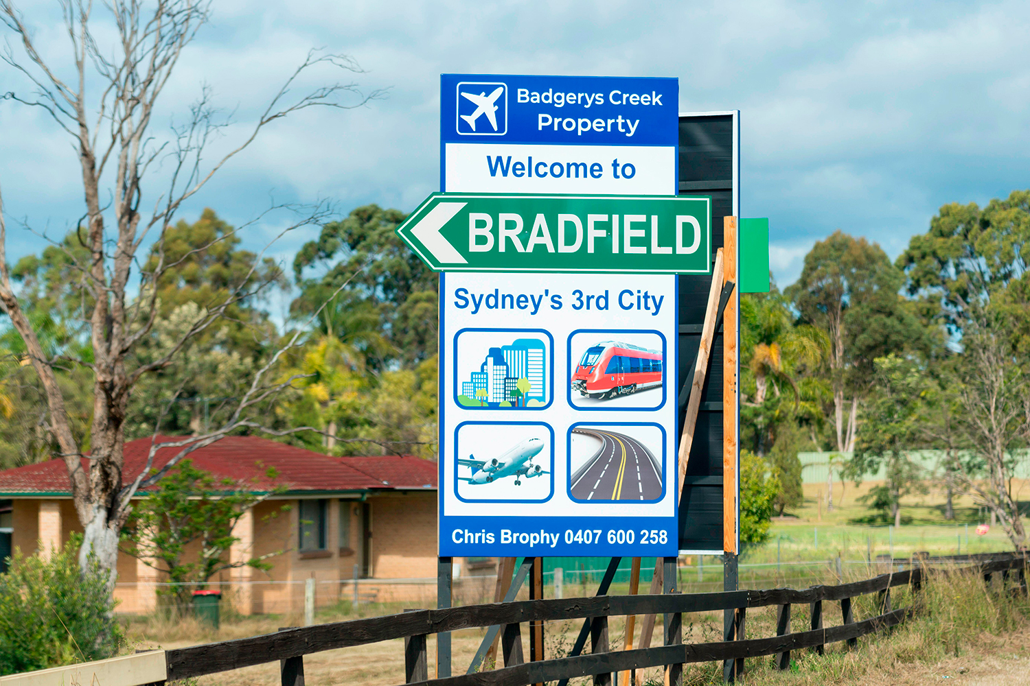 A sign in front of a building and some land says Welcome to Bradfield, Sydney’s third city.