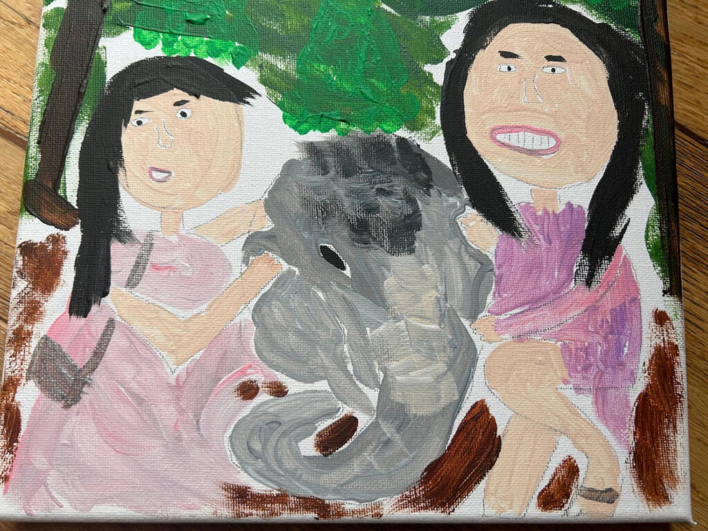 A painting shows two people smiling and holding an elephant by the ears.