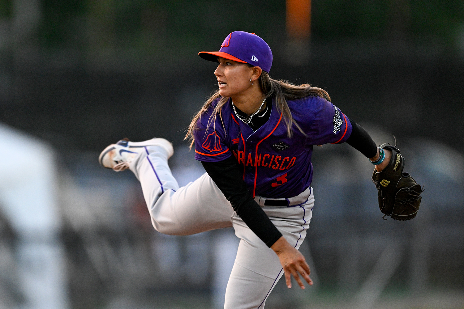 Kelsie Whitmore looks straight ahead while still in position after having pitched a ball.