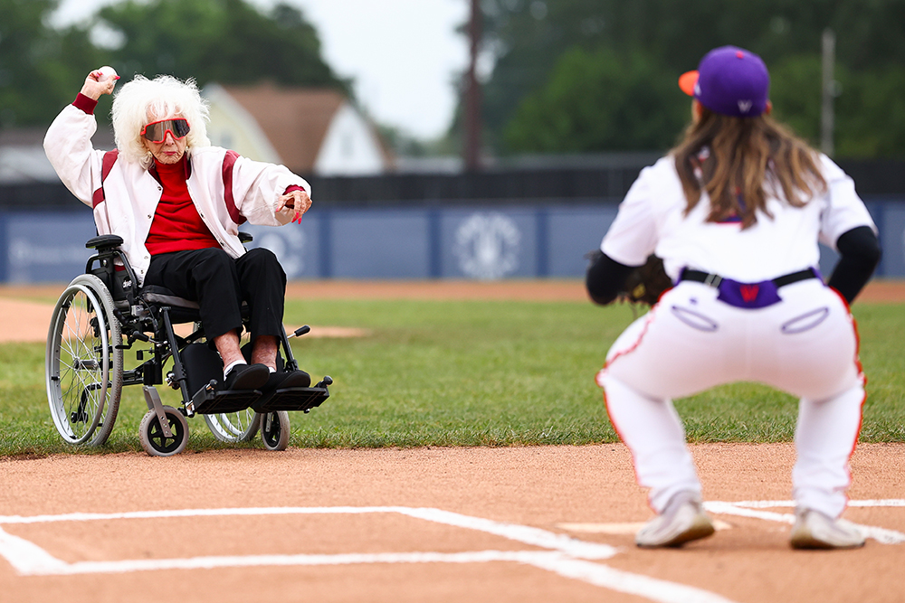Maybelle Blair sits in a wheelchair as she throws a baseball to Kelsie Whitmore.